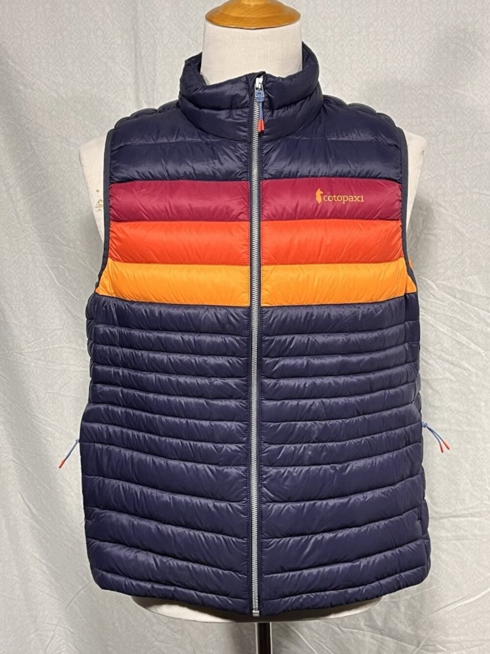 cotopaxi Navy Puffer Vest with Red, Orange & Yellow Stripes